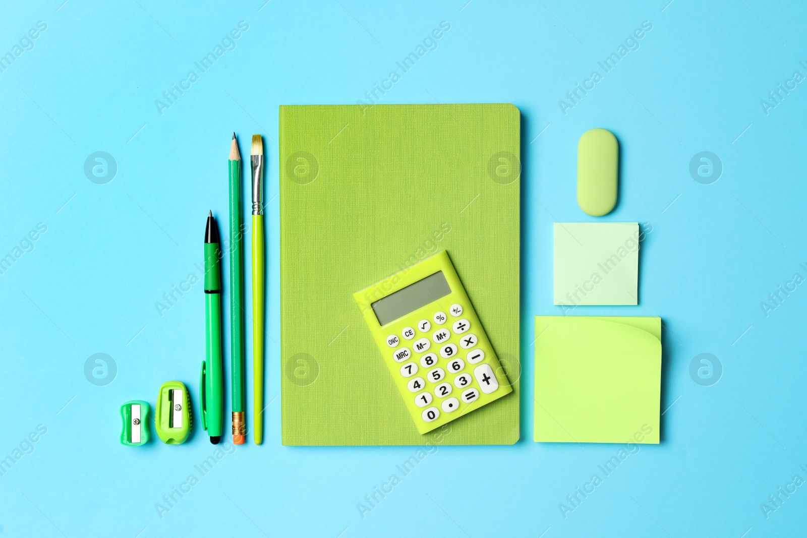 Photo of Flat lay composition with different school stationery on light blue background. Back to school