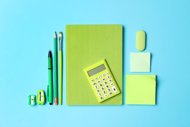 Photo of Flat lay composition with different school stationery on light blue background. Back to school