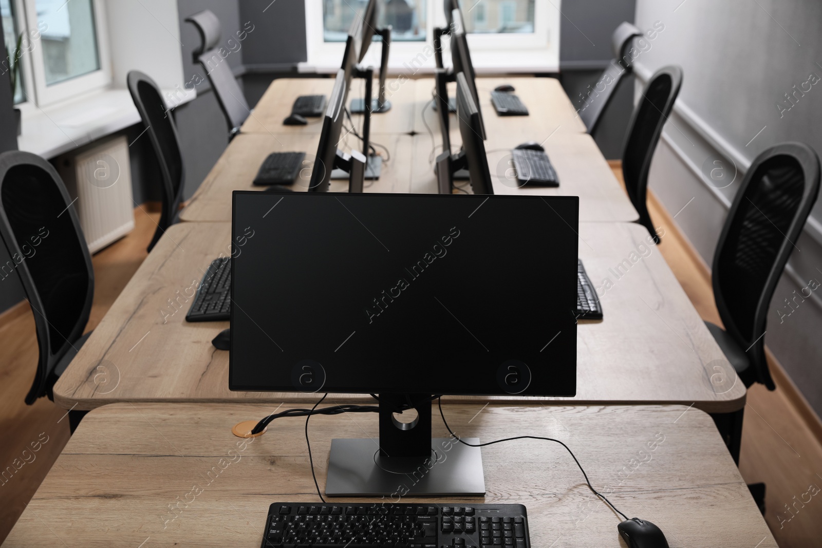 Photo of Many modern computers in open space office