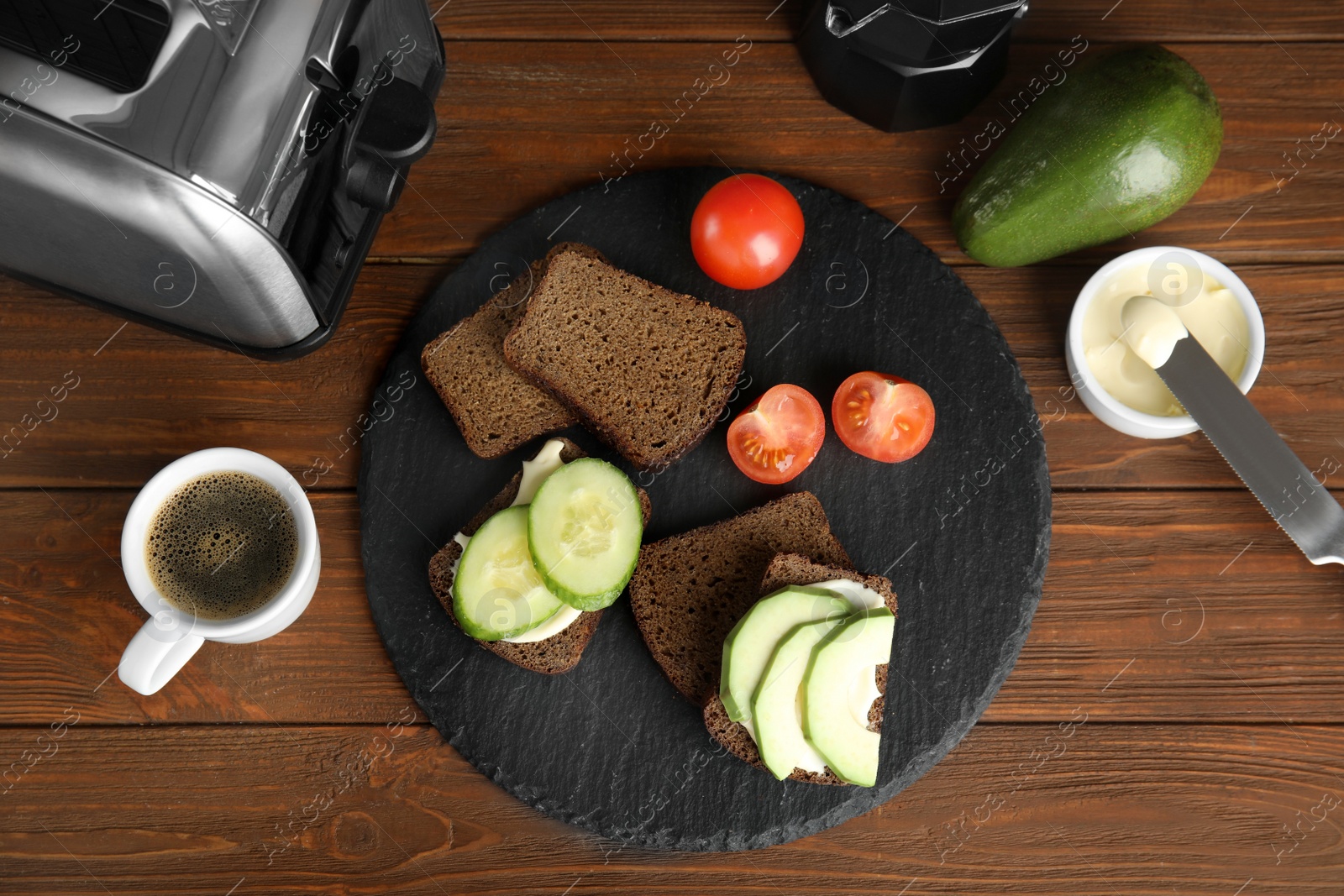 Photo of Slices of bread with different toppings on wooden table, flat lay