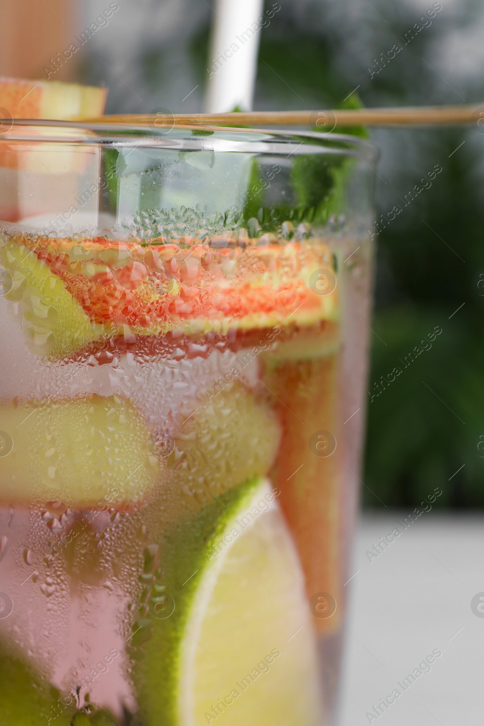Photo of Glass of tasty rhubarb cocktail with lime, closeup