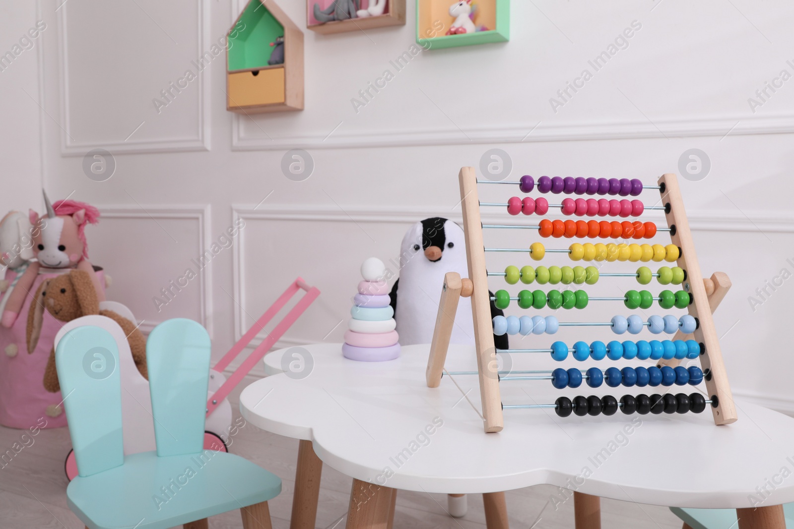Photo of Cute child's playroom with toys and modern furniture. Interior design