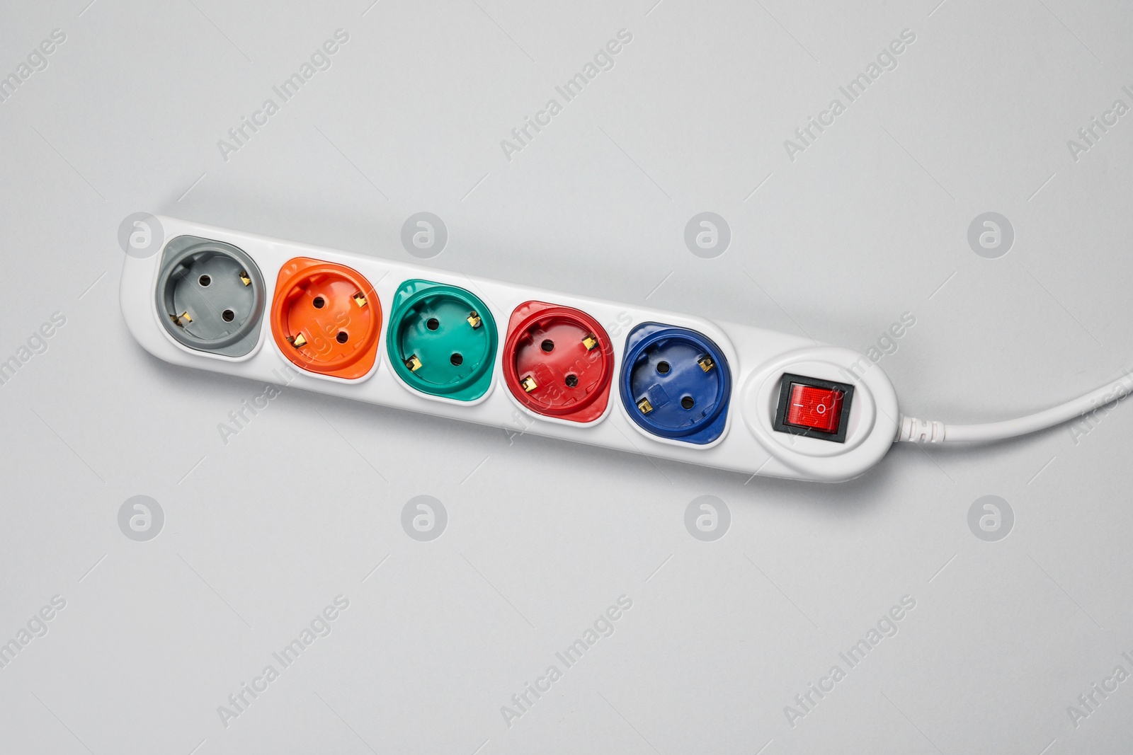 Photo of Power strip with switch button on white background, top view