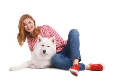 Beautiful woman with her cute dog on white background