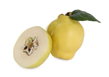 Photo of Whole and cut delicious quinces on white background