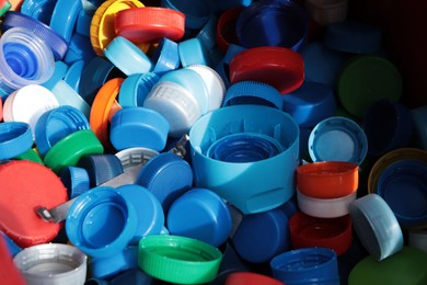 Photo of Different colorful bottle caps, closeup. Plastic recycling