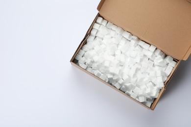 Cardboard box with styrofoam cubes isolated on white, top view