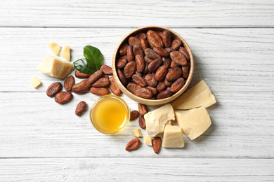 Flat lay composition with organic cocoa butter on white wooden table