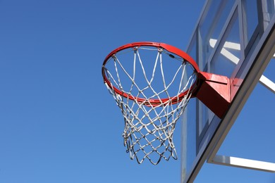 Photo of Basketball hoop with net outdoors on sunny day, space for text