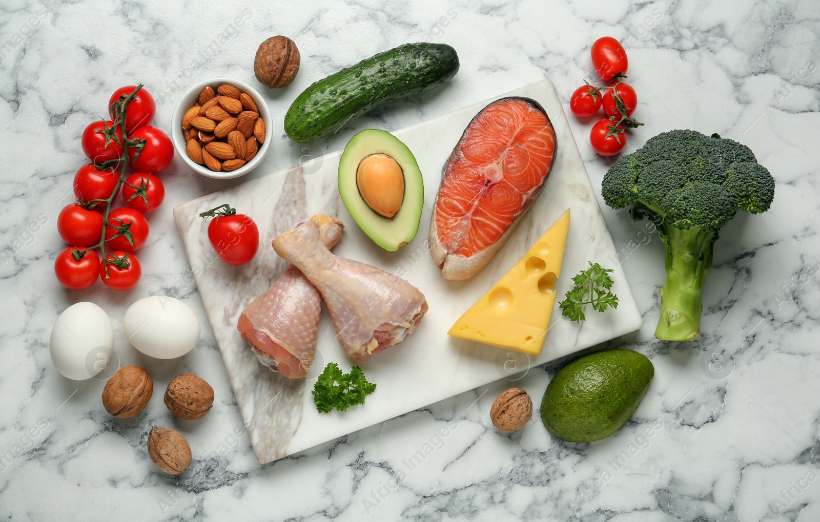 Photo of Flat lay composition with different fresh products on white marble table. Keto diet