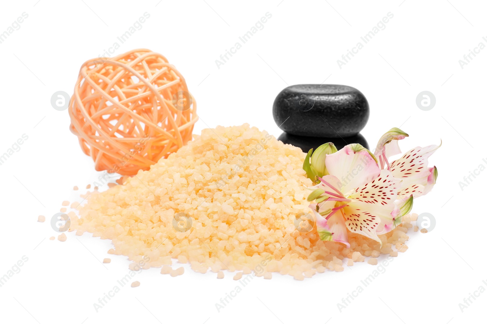 Photo of Orange sea salt, flower, spa stones and rattan ball isolated on white