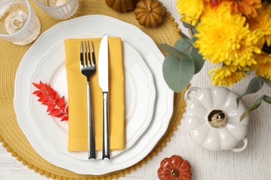 Photo of Autumn table setting with floral decor and pumpkins, flat lay