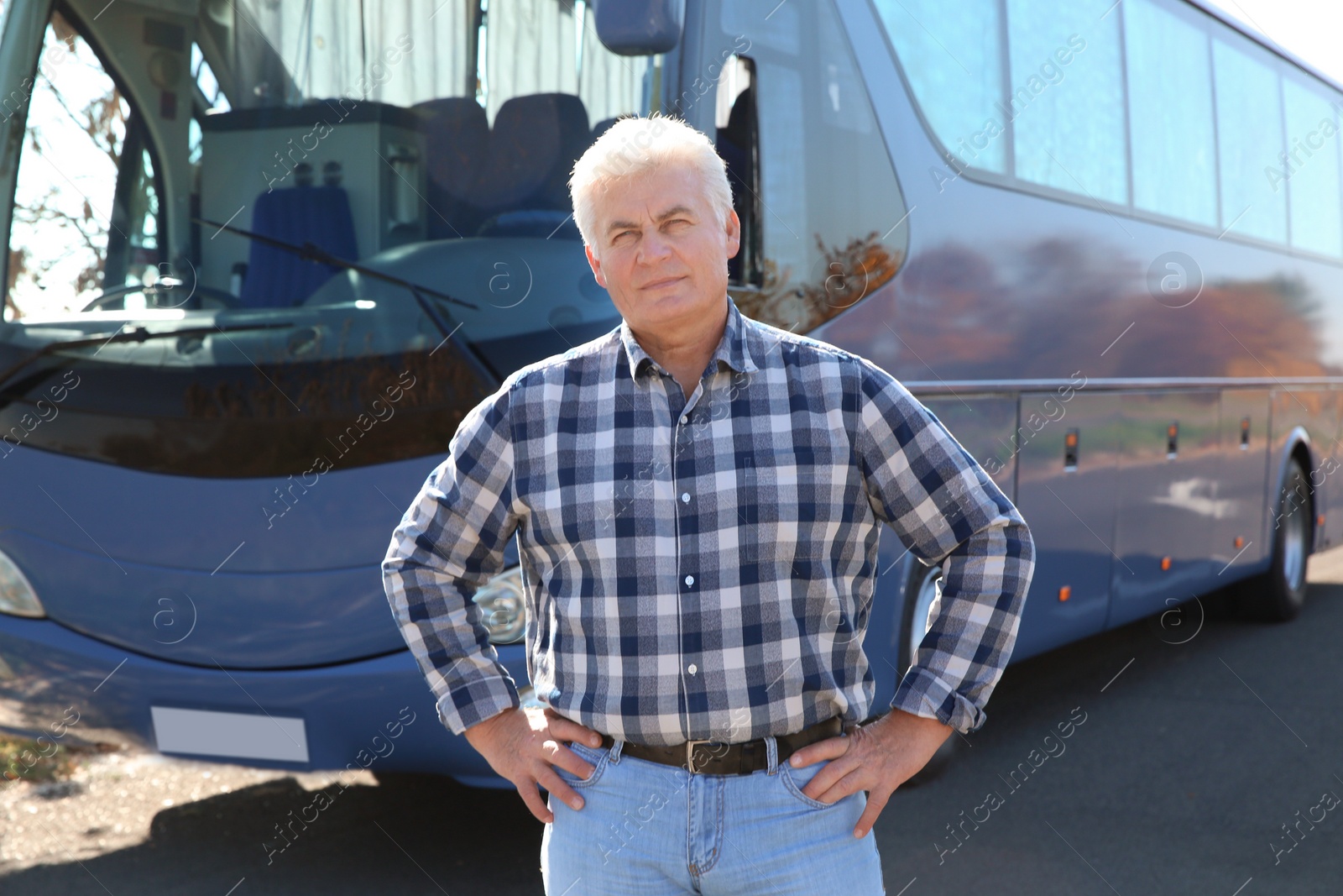Photo of Professional driver standing near bus. Passenger transportation