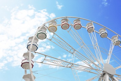 Large white observation wheel against sky, low angle view