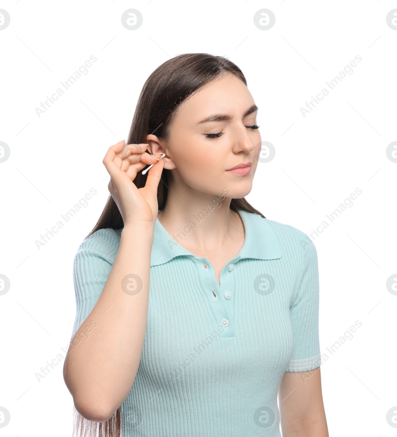 Photo of Young woman cleaning ear with cotton swab on white background