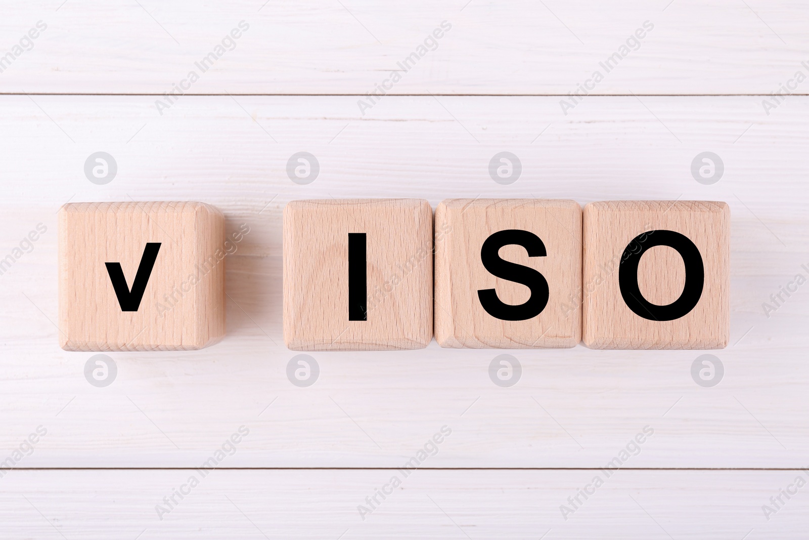 Photo of International Organization for Standardization. Cubes with check mark and abbreviation ISO on white wooden table, flat lay