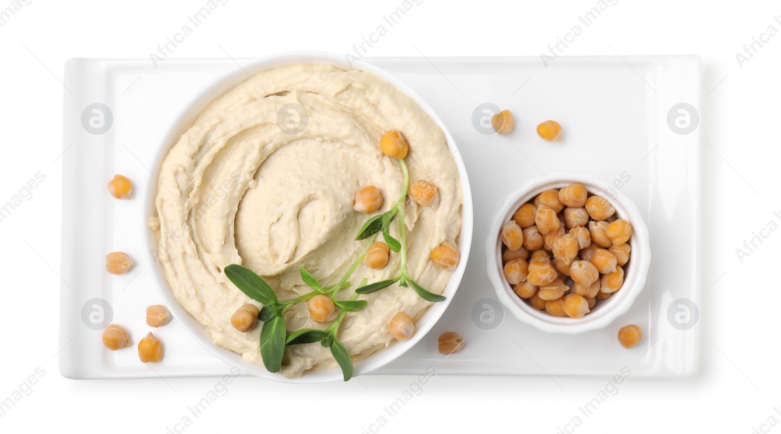 Photo of Bowl of delicious hummus with chickpeas isolated on white, top view