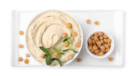 Photo of Bowl of delicious hummus with chickpeas isolated on white, top view
