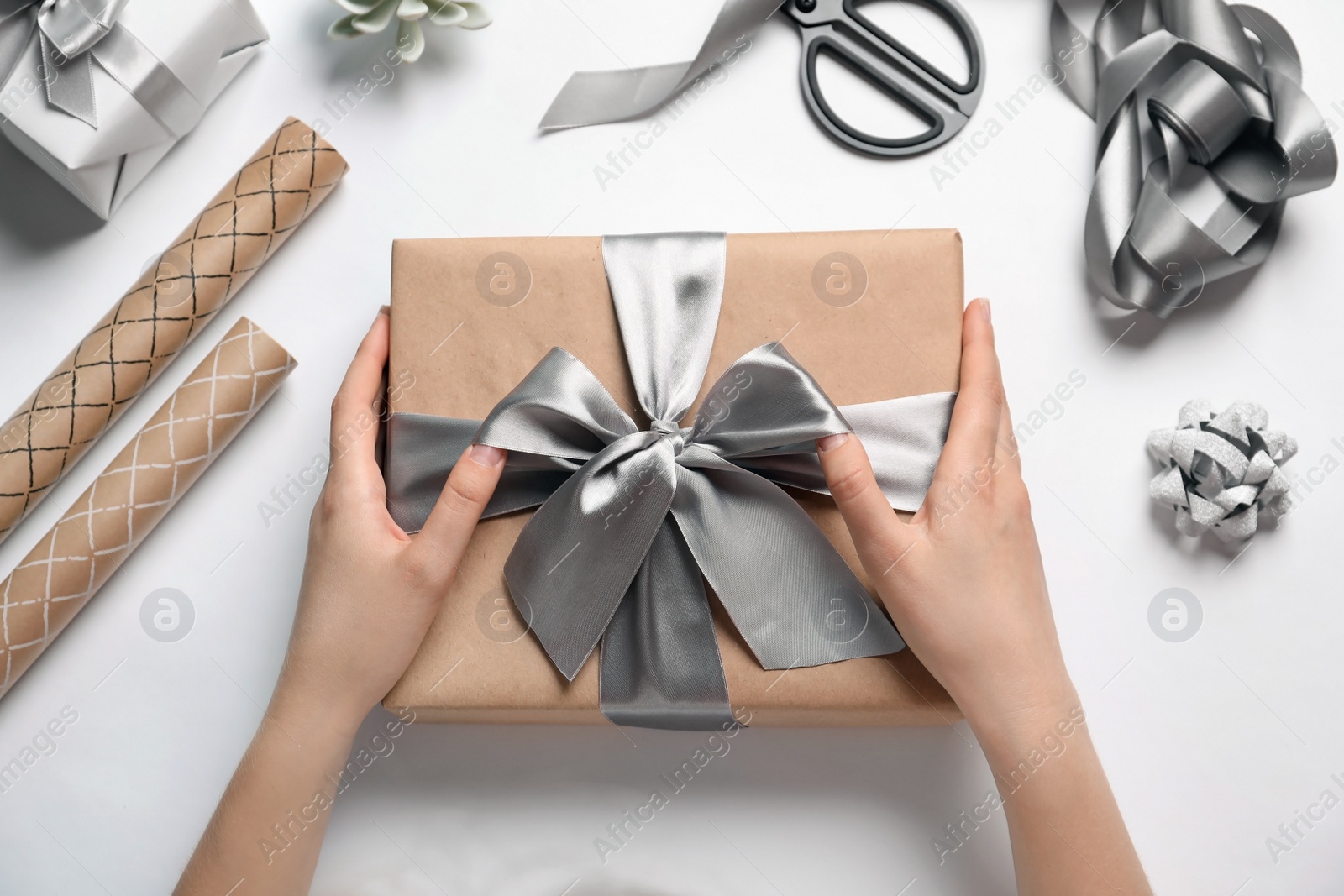 Photo of Woman with beautiful gift box on white background, top view