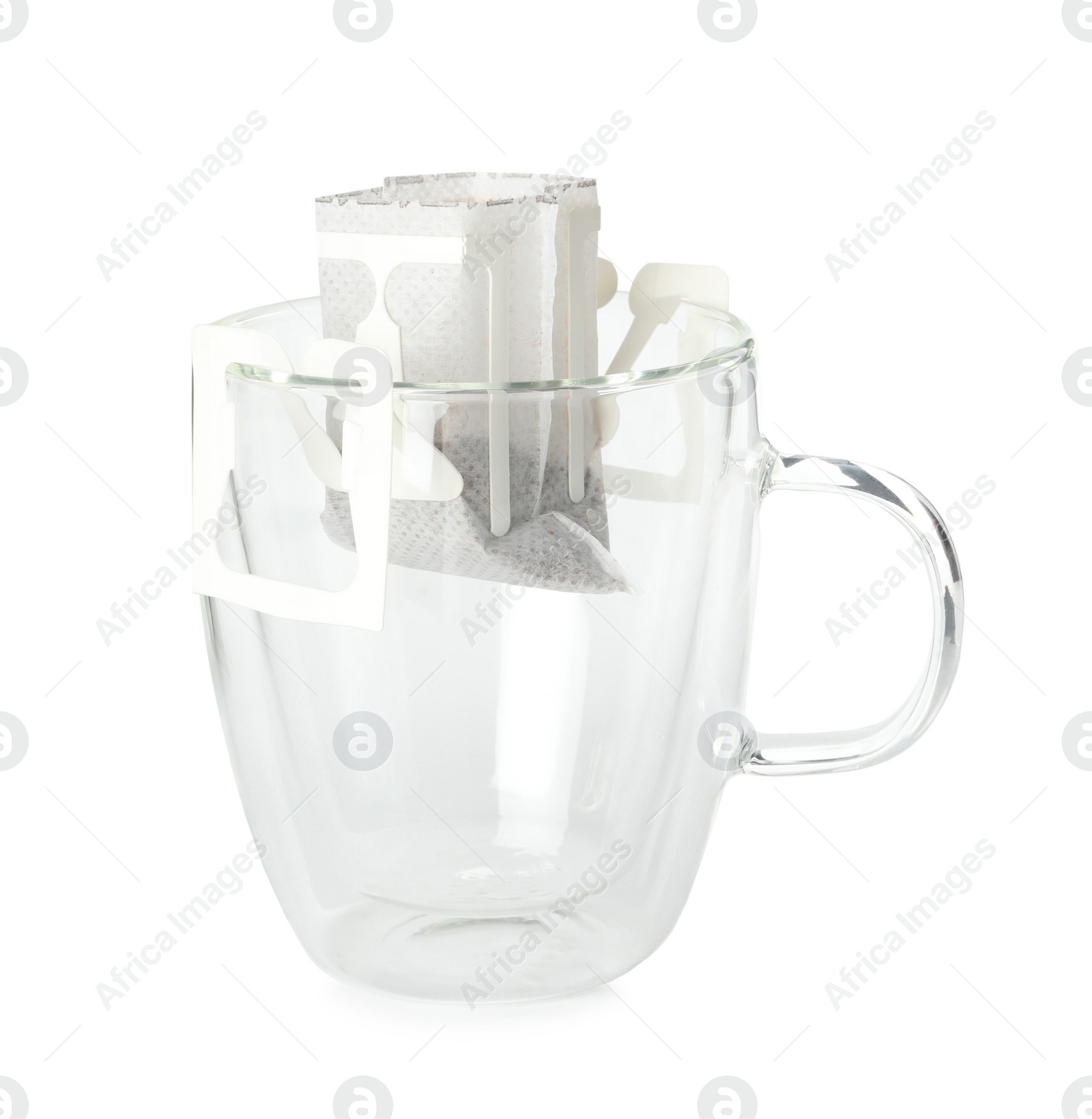 Photo of Glass cup with drip coffee bag isolated on white