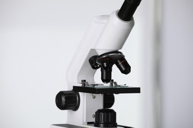 Modern microscope on light background, closeup. Medical equipment