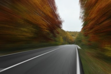 Image of Asphalt country road in autumn, motion blur effect