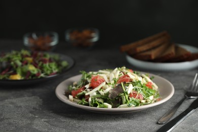 Photo of Delicious carrot salad served on grey table