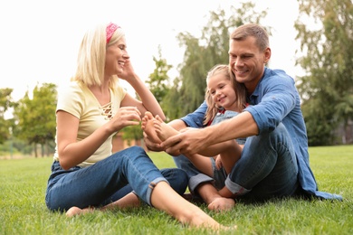 Photo of Happy family spending time together in park on sunny summer day