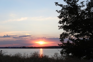 Photo of Picturesque view of beautiful sunrise on riverside. Morning sky