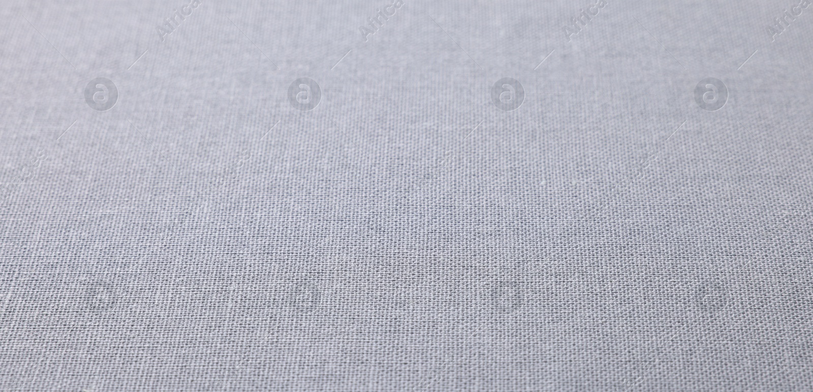 Photo of Texture of light grey fabric as background, closeup