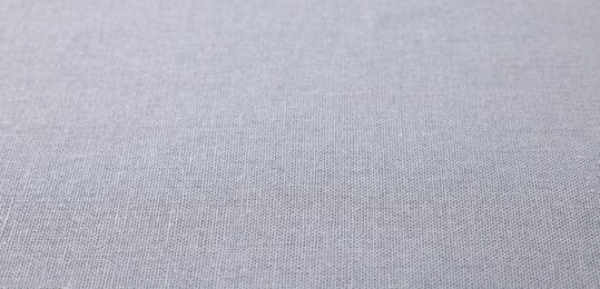 Photo of Texture of light grey fabric as background, closeup