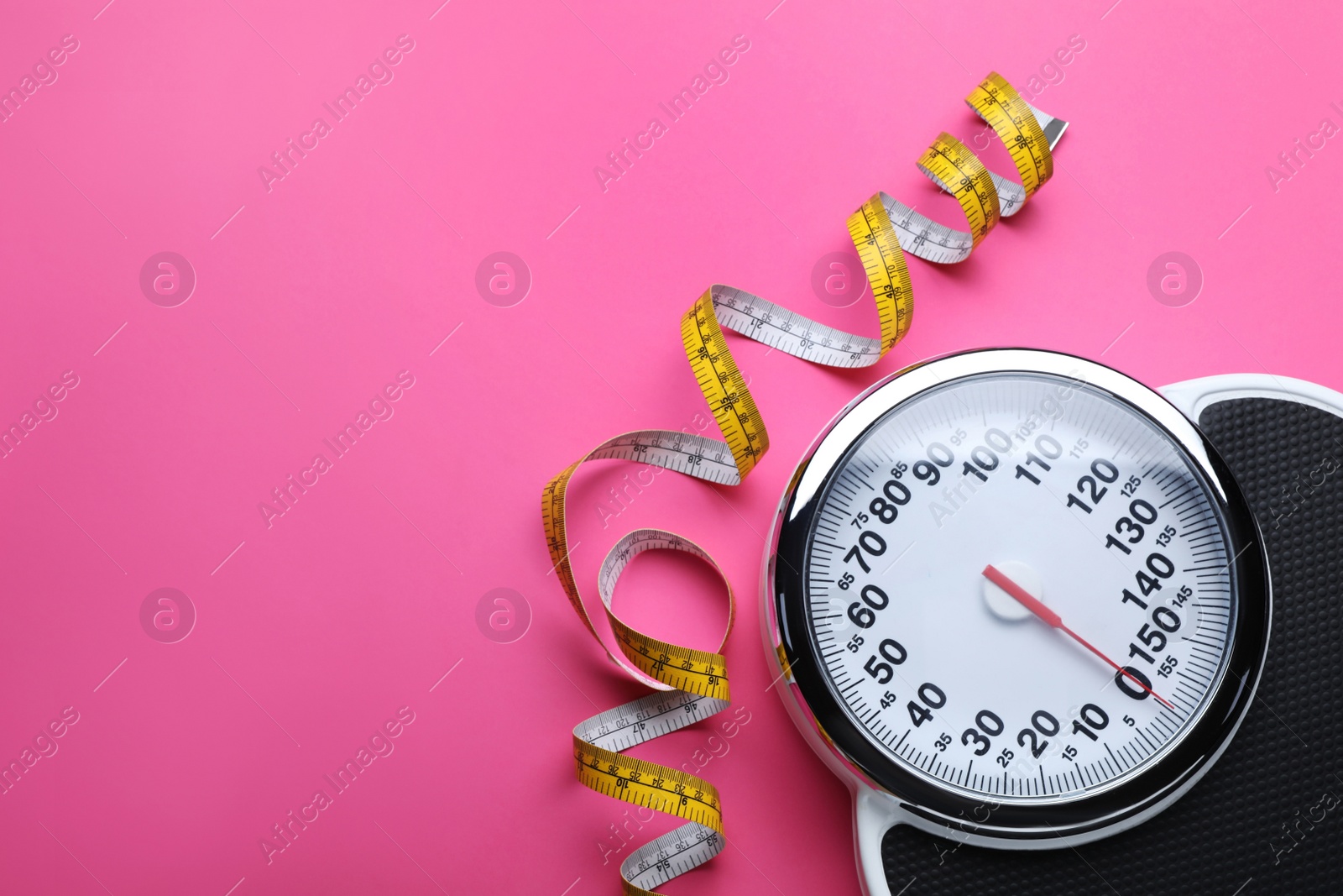 Photo of Scales and measuring tape on pink background, flat lay. Space for text