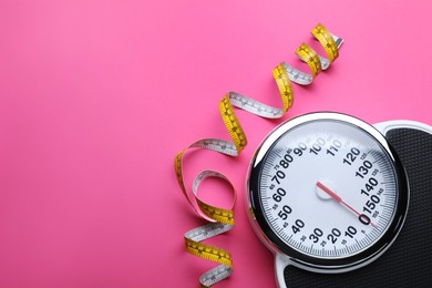 Scales and measuring tape on pink background, flat lay. Space for text