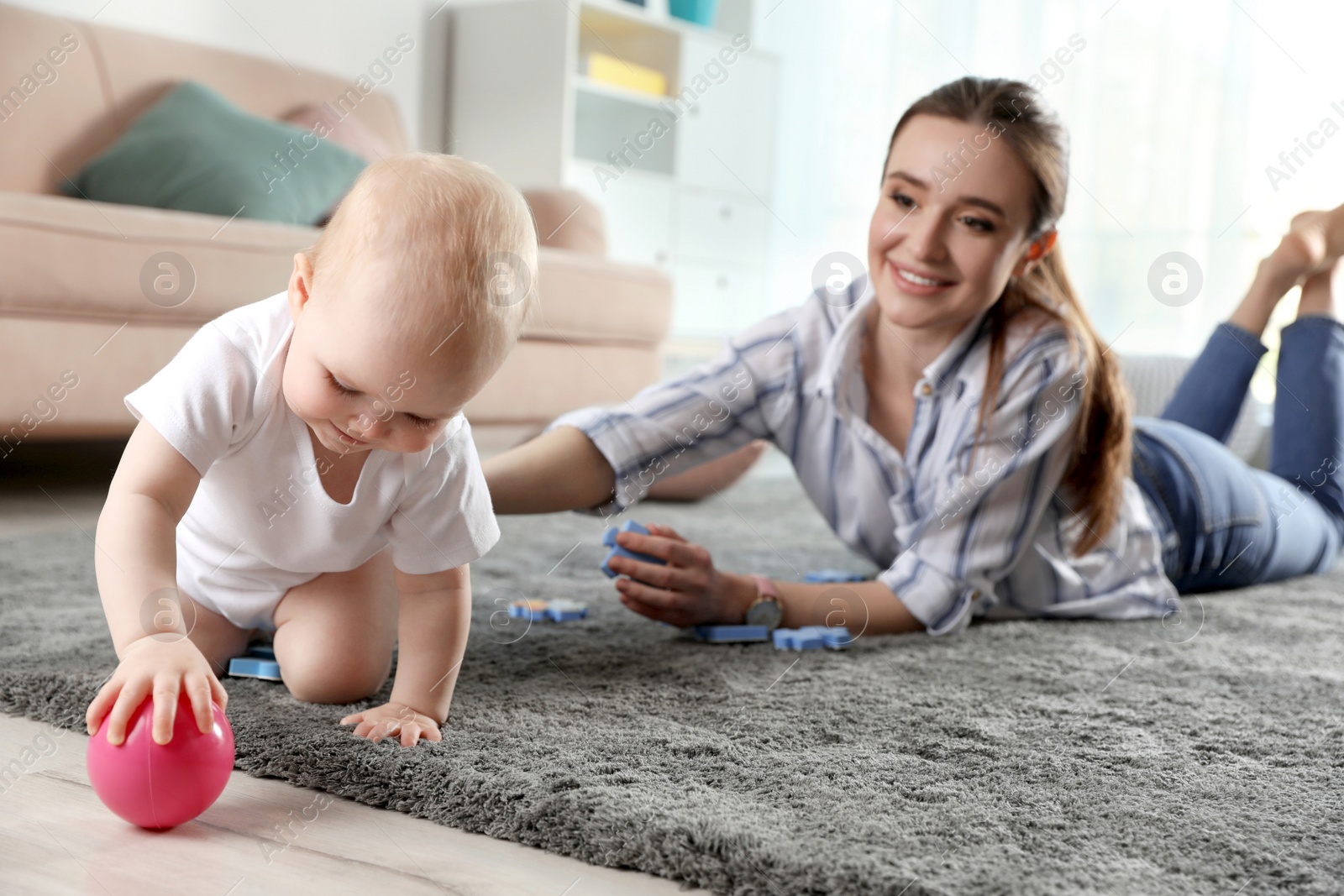 Photo of Adorable little baby crawling near mother at home