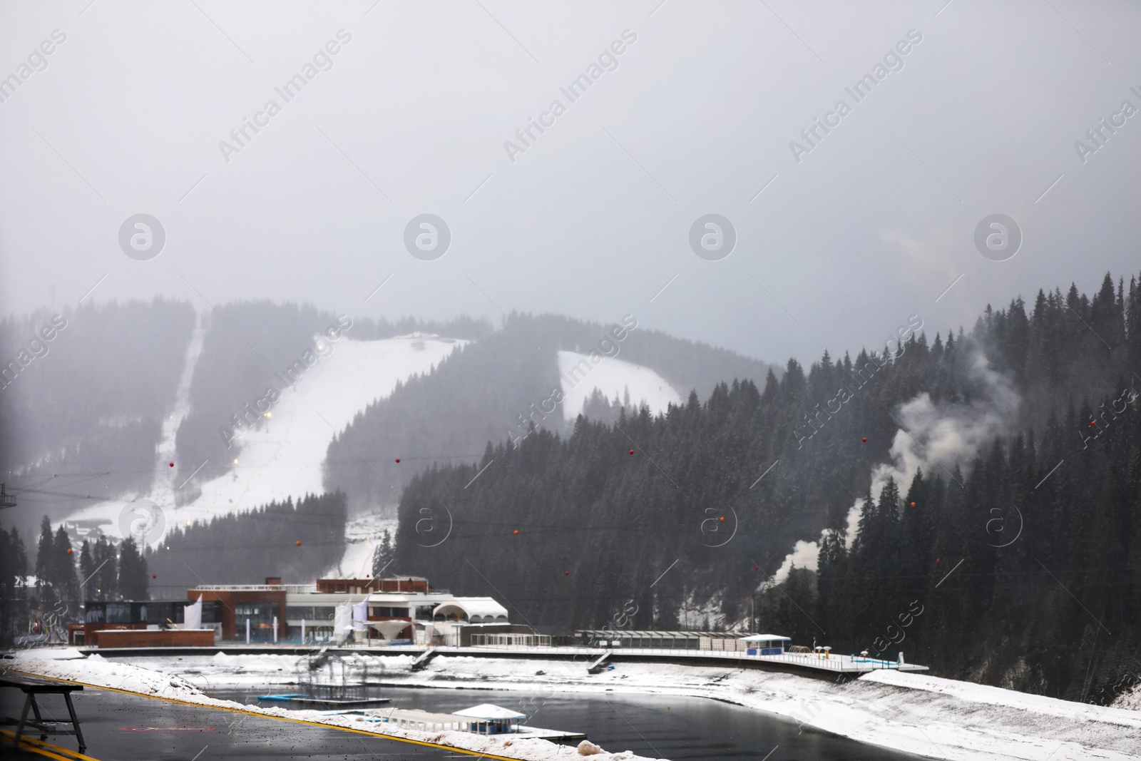 Photo of Beautiful view of resort near forest on snowy day. Winter vacation