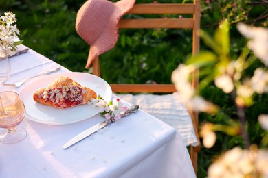 Photo of Stylish table setting with beautiful spring flowers in garden