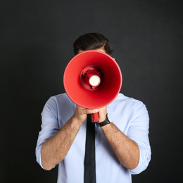 Man with red megaphone on black background