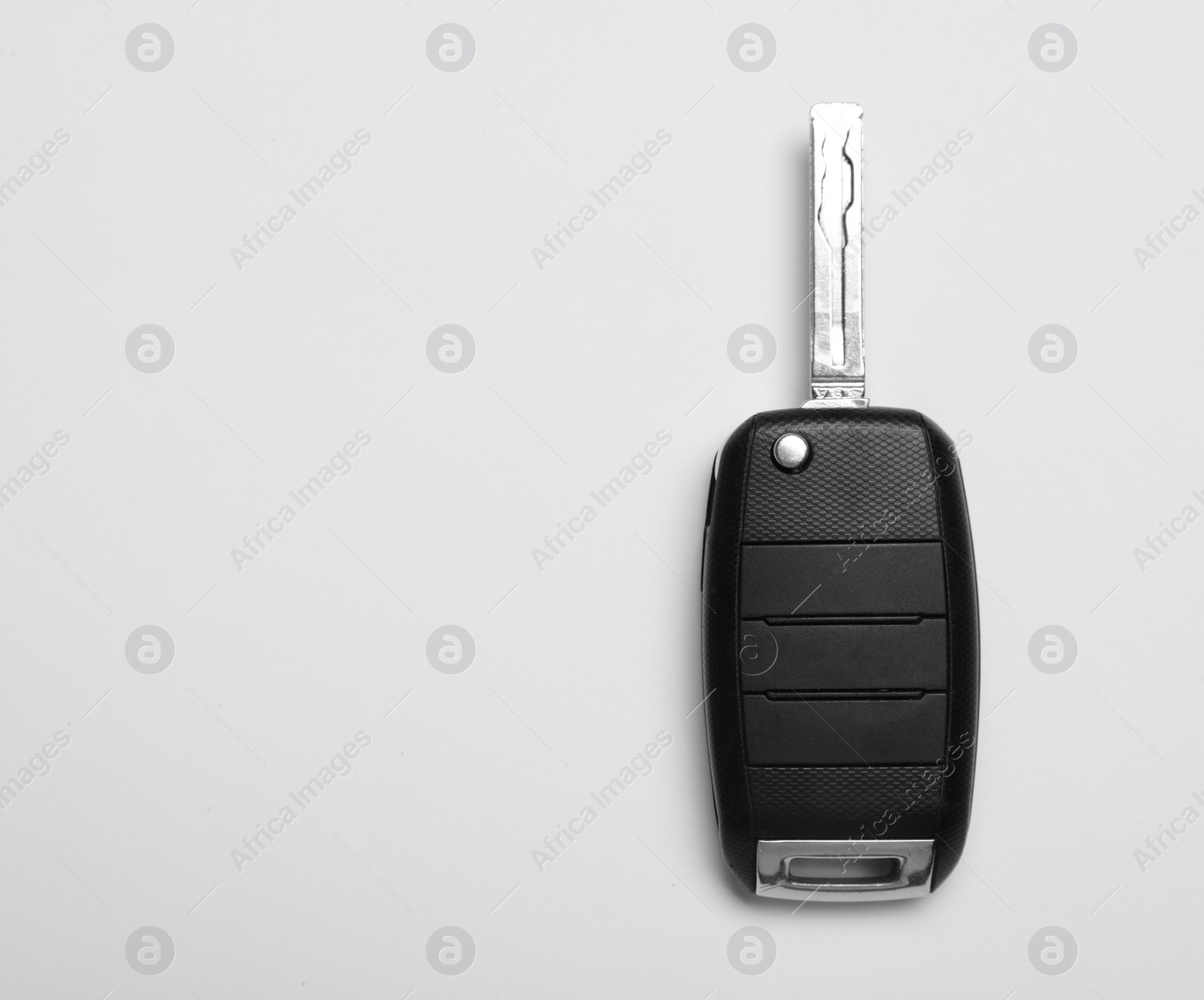 Photo of Car key on white background, top view. Space for text