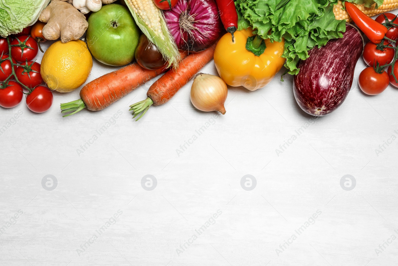 Photo of Different fresh vegetables on light table, flat lay. Space for text