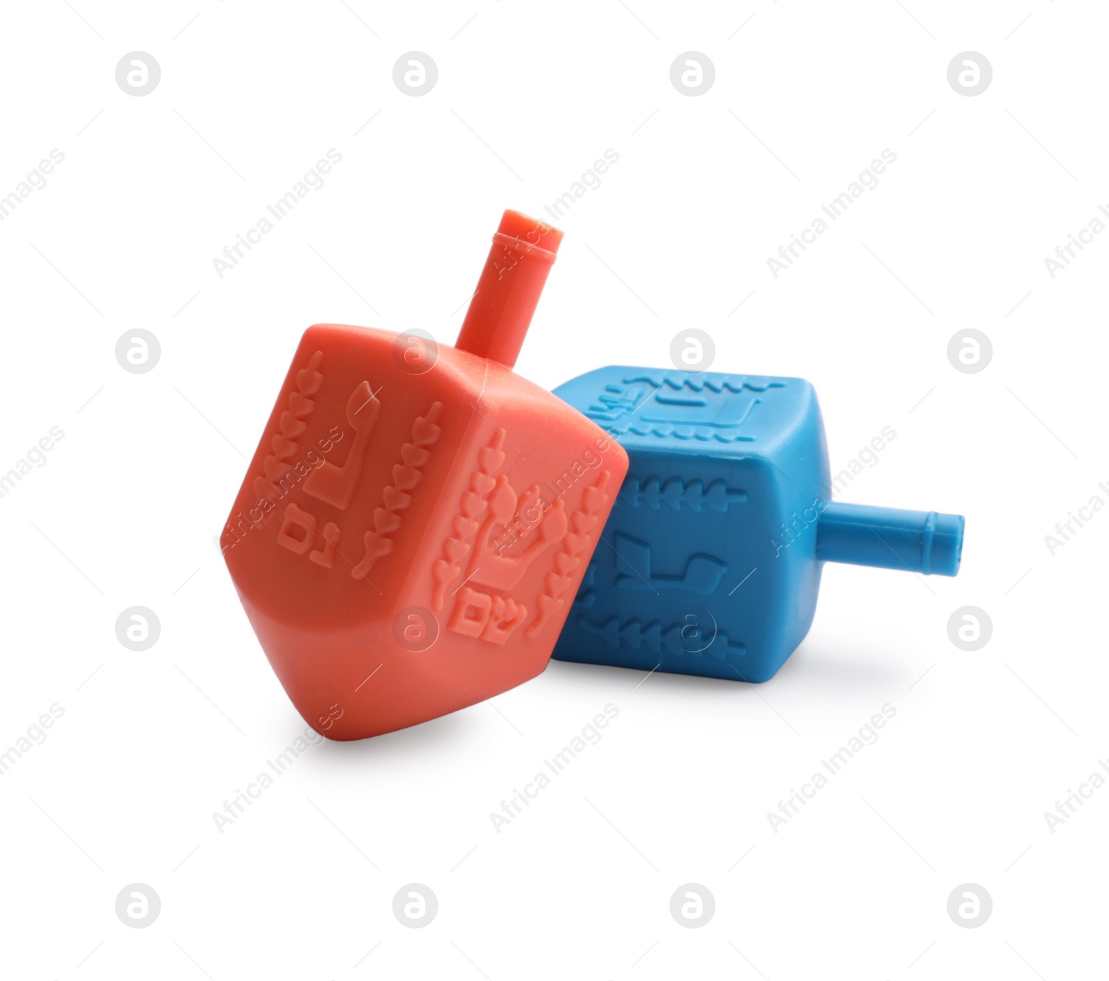 Photo of Colorful dreidels isolated on white. Traditional Hanukkah game