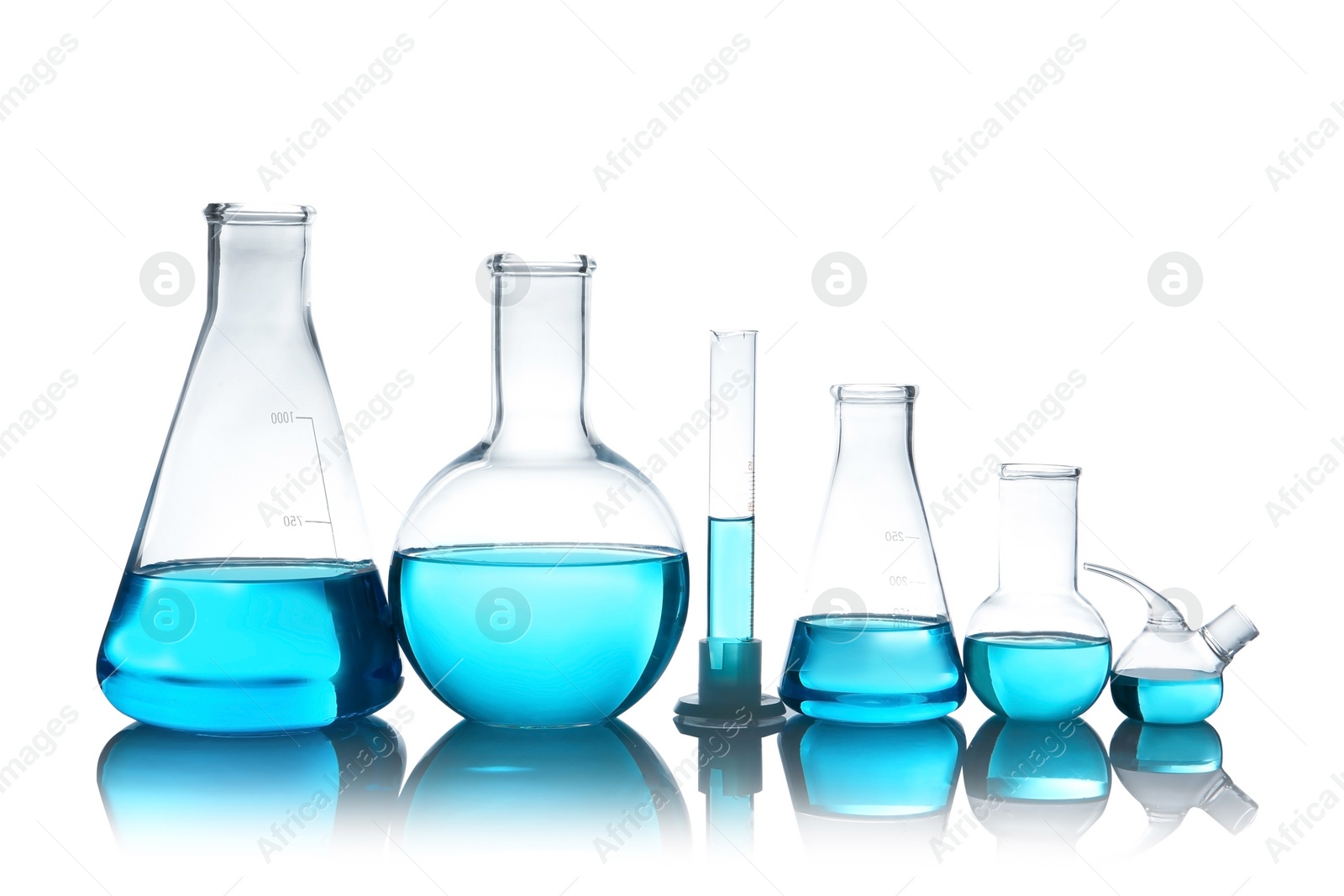 Photo of Laboratory glassware with liquid on table against white background. Chemical analysis