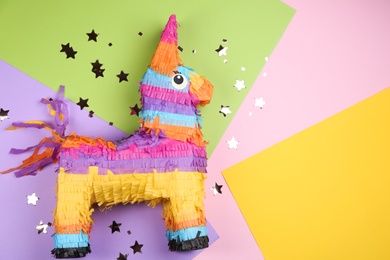 llama shaped pinata and glitter on color background, flat lay. Space for text