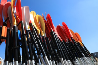 Photo of Storage rack with paddles for kayaks against blue sky