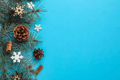 Winter composition with fir tree on light blue background, flat lay. Space for text