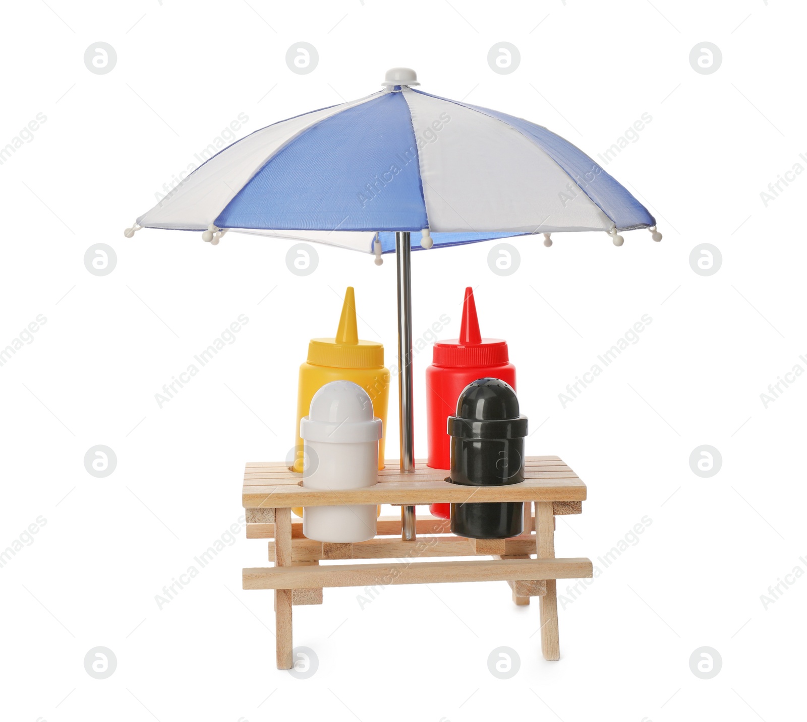 Photo of Set of sauce bottles with salt and pepper shakers in creative holder on white background