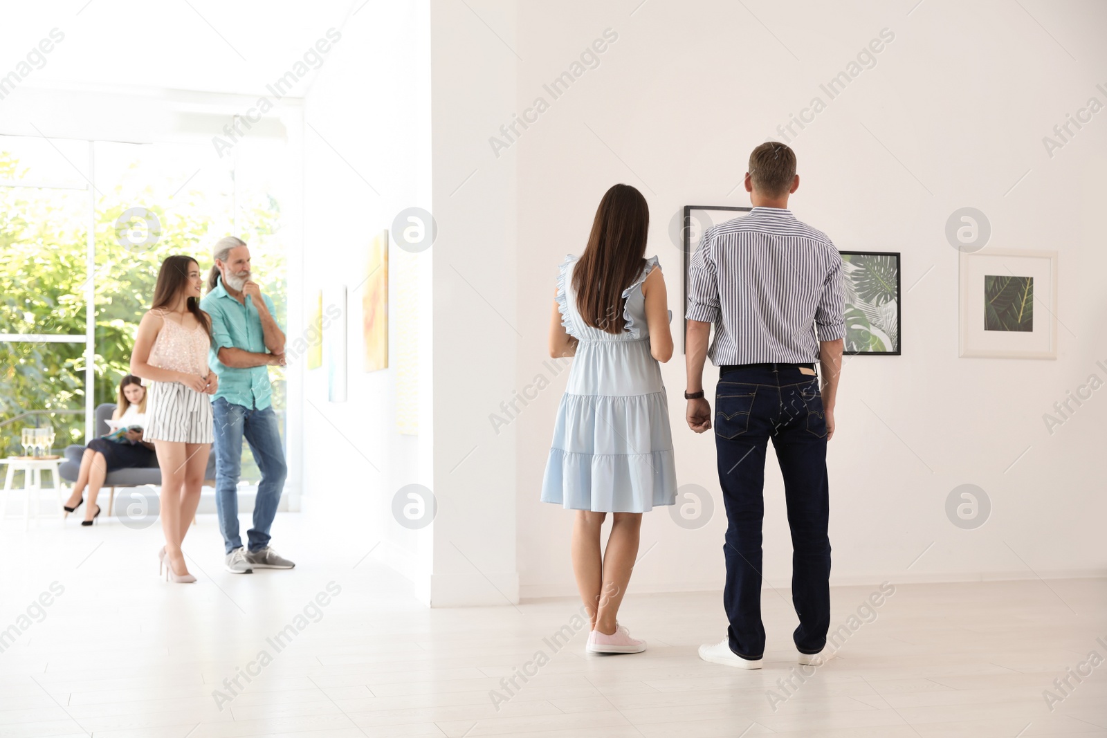 Photo of Young couple at exhibition in art gallery