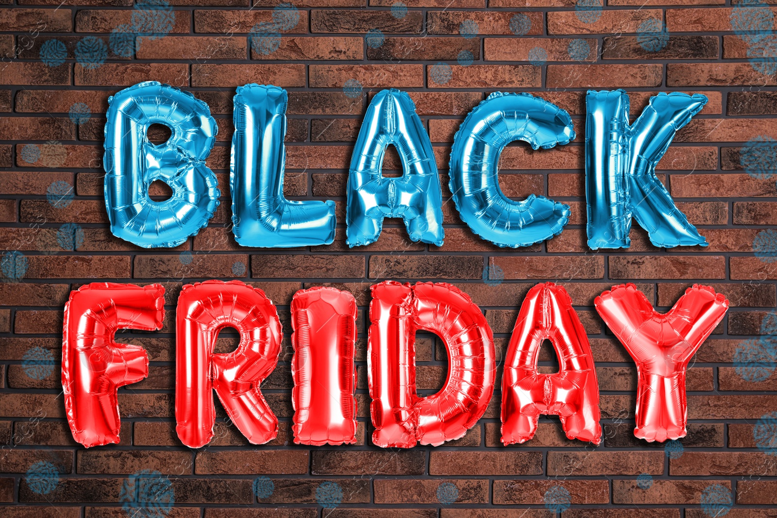 Image of Phrase BLACK FRIDAY made of foil balloon letters against brick wall