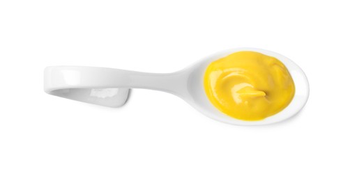 Photo of Mustard in ceramic serving spoon isolated on white, top view