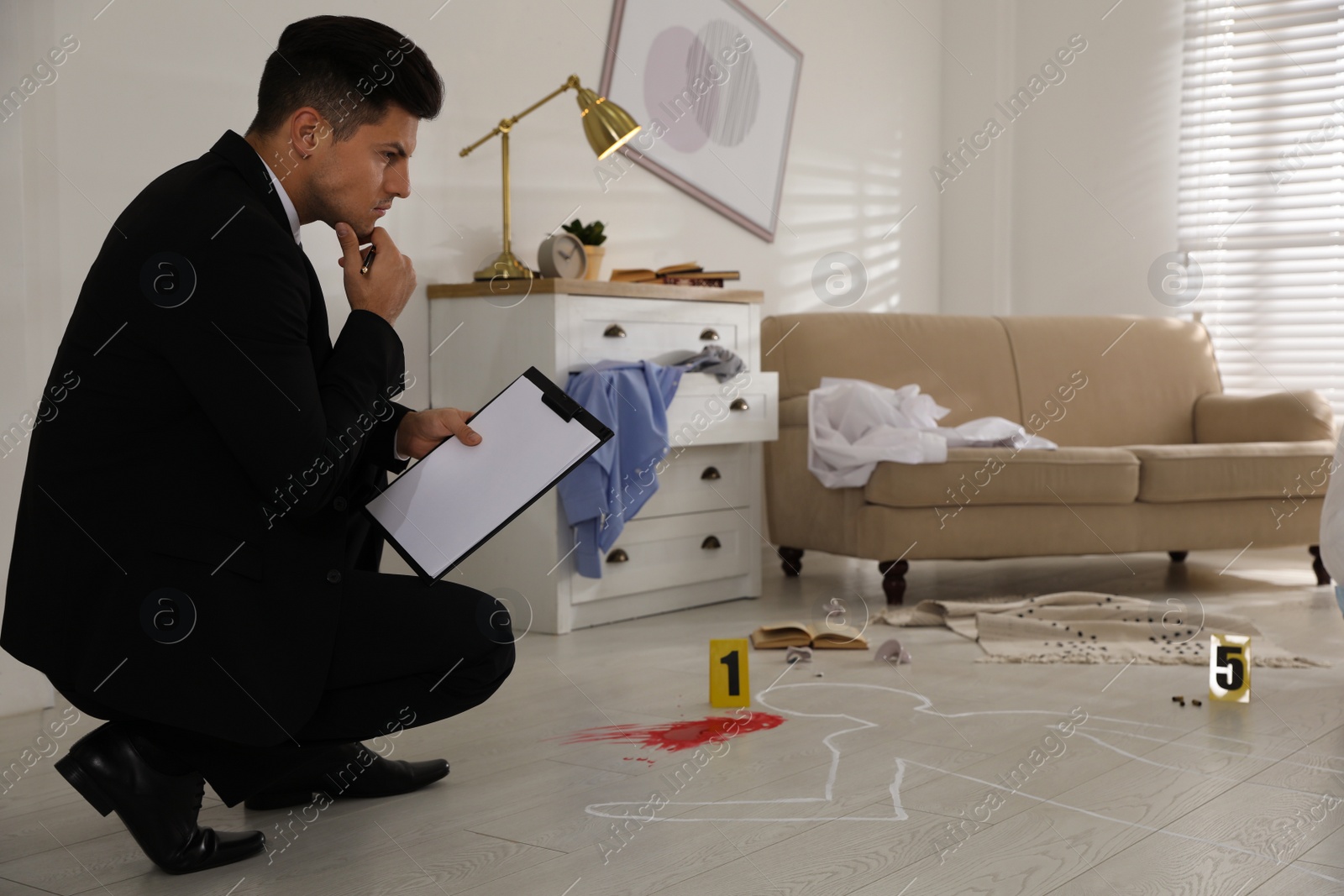 Photo of Investigator in black suit examining crime scene