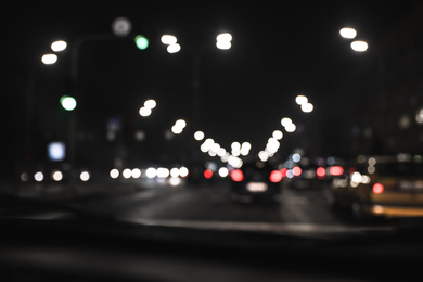 Blurred view of road with cars at night. Bokeh effect